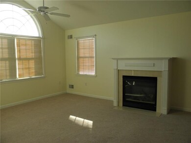 Vaulted ceiling in living room and gas log firepla