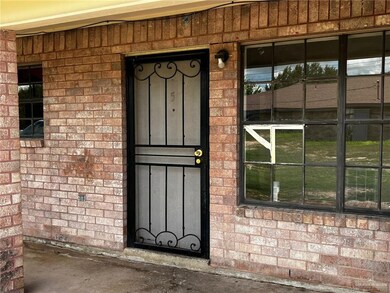 View of exterior entry with brick siding