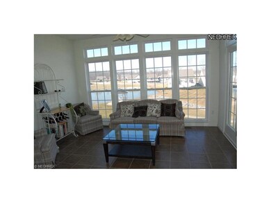 Lake view from lovely sunroom with ceramic tile fl
