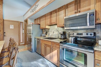 Kitchen with sink, light tile patterned floors, st