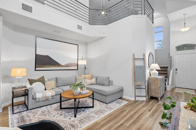Living area featuring baseboards, visible vents, 