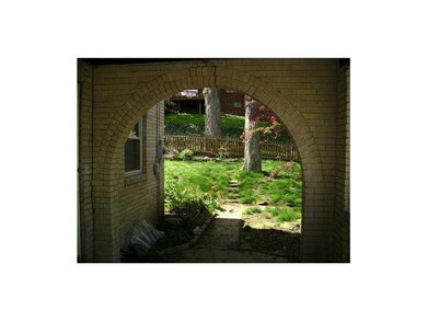 Exterior Front. Arch of Front Porch into fenced in