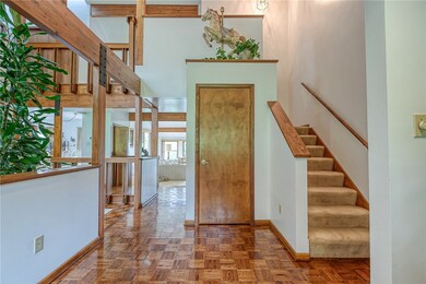 Step into the impressive entry with gleaming wood