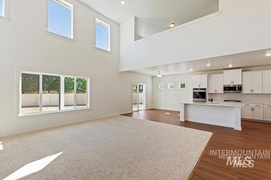 Unfurnished living room with healthy amount of natural light, dark wood-style flooring, a high ceiling, and recessed lighting