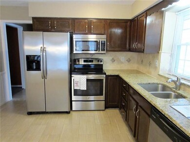 Granite countertops with mosaic tile backsplash.