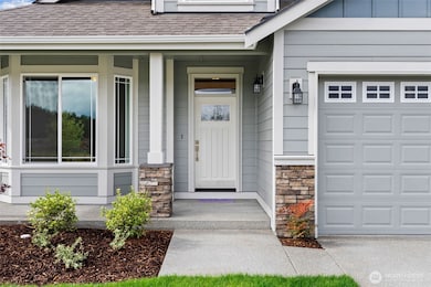 Our Redwood one story floor plan has the perfect covered porch entry with stone accents to welcome you and your guests.