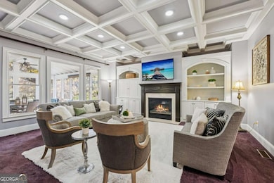 Stunning family room with coffered ceilings, custom built-ins, and a cozy fireplace creating the perfect gathering space.