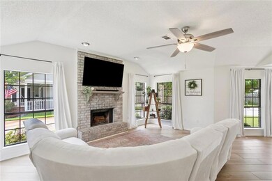 Den with vaulted ceiling, wood burning fireplace