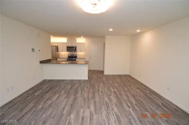 Unfurnished living room featuring dark wood-type f