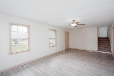 Spare room with healthy amount of natural light, l