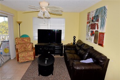 UPPER LEFT UNIT:  LIVING ROOM.  TILED FLOOR.  ENTR
