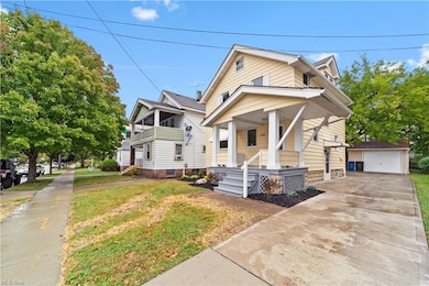 Bungalow-style home with a front yard, covered porch, and a garage