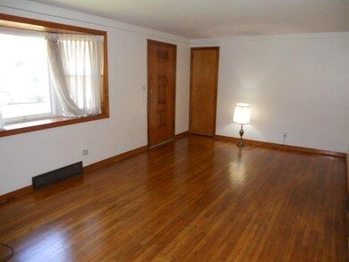 Living Room with hardwood floors and bay window, s