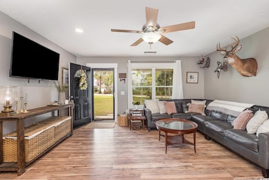 Living room with light wood-type flooring, recesse