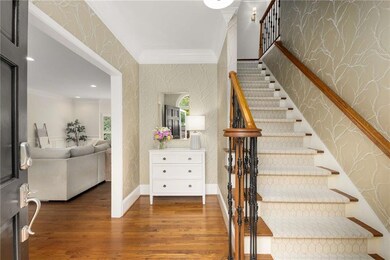 Come on in to this beautiful home with gleaming hardwood floors, fresh paint throughout and custom wallpaper in the entry.