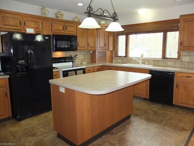 Fully applianced kitchen with center island.