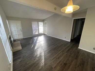 Unfurnished living room featuring dark wood-style