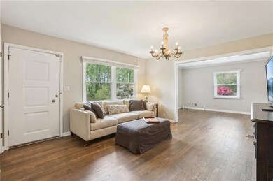 Living room with baseboards, dark wood-style floor