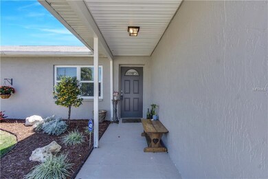 Inviting covered front entryway with landscaping.