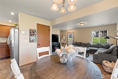 Main level features kitchen, dining area, and living area with patio and yard access