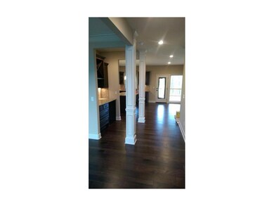 Open walkway from foyer to a butler's pantry then 