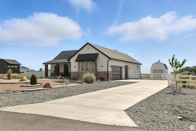 View of front of house with driveway, a garage, and a shingled roof