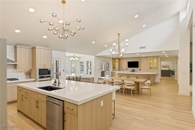 Kitchen featuring a chandelier, light brown cabine