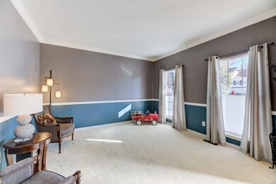 Formal living room also has arched entry and crown