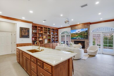 Kitchen with visible vents, an island with sink, 