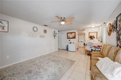 Living area with visible vents, baseboards, light 