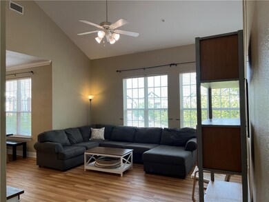 Living room featuring ceiling fan, high vaulted ce
