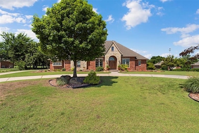 View of front of house with brick siding, a front lawn, and stone siding