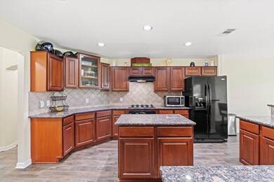Kitchen featuring black fridge, under cabinet ran