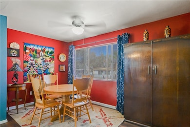 spacious casual dinning area featuring a large window, natural lighting, uniquely decorated and designed