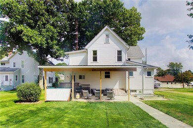 West View Back of property featuring a yard and a 