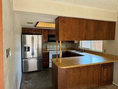 Kitchen featuring a textured ceiling, stainless st