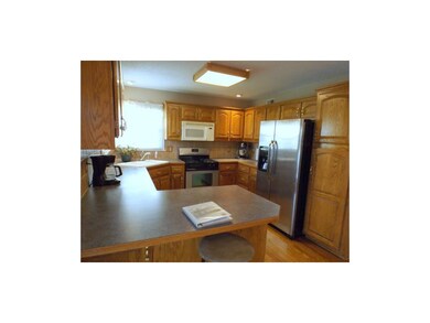 Kitchen has breakfast bar, tons of cabinets, stain