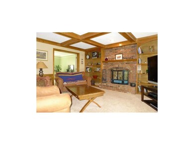 Brick fireplace flanked by built-ins.