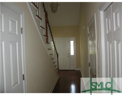 Foyer. Hallway with half bathroom on the left look