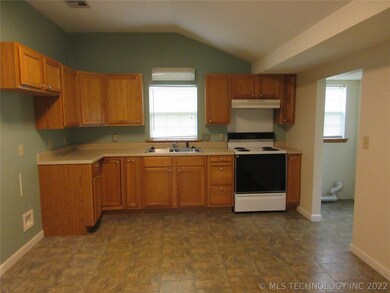 Country kitchen with utility right entrance.