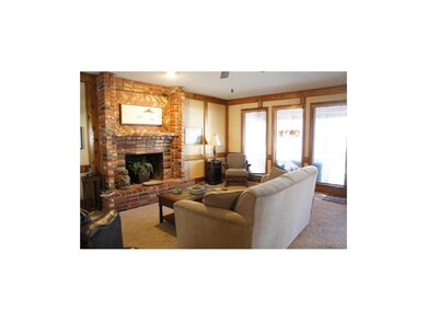 Large brick fireplace in family room with access t