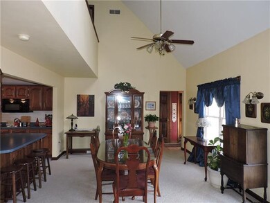 The living room is open to the dining area and kit