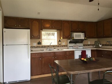 Newer fridge, stove and microwave and kitchen ware