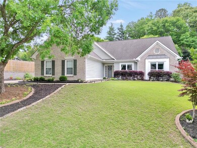 Ranch-style home with brick siding and a shingled roof