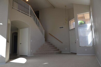Living room looking at front door/stairs
