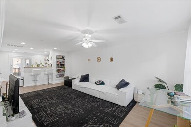Living room with wood finished floors, a ceiling f