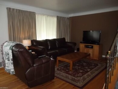 The living room offers beautiful hardwood floors a