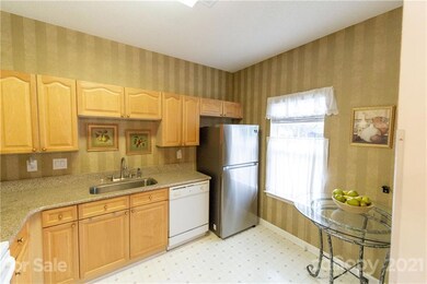 Kitchen large enough to have a dinnette set or use the dining area.  Refrigerator stays as do the stack washer and dryer.