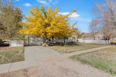 View of front facade with concrete driveway, covered porch, and a garage