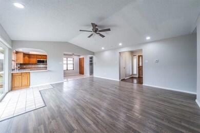 Unfurnished living room featuring lofted ceiling, 